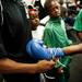 A young boxer has his gloves taped up at the A-Square Fight Club Boxing Showcase on Friday, July 19. Daniel Brenner I AnnArbor.com